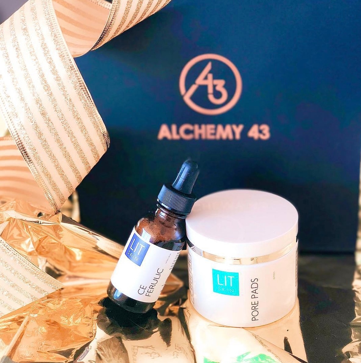 Skincare products on golden gift wrapping.