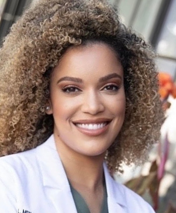 Young woman smiling with long hair.
