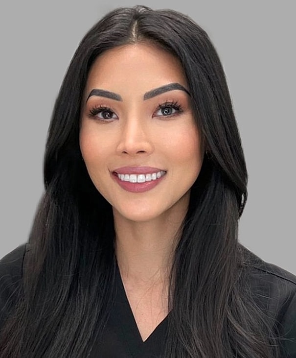 Young woman smiling with long hair.