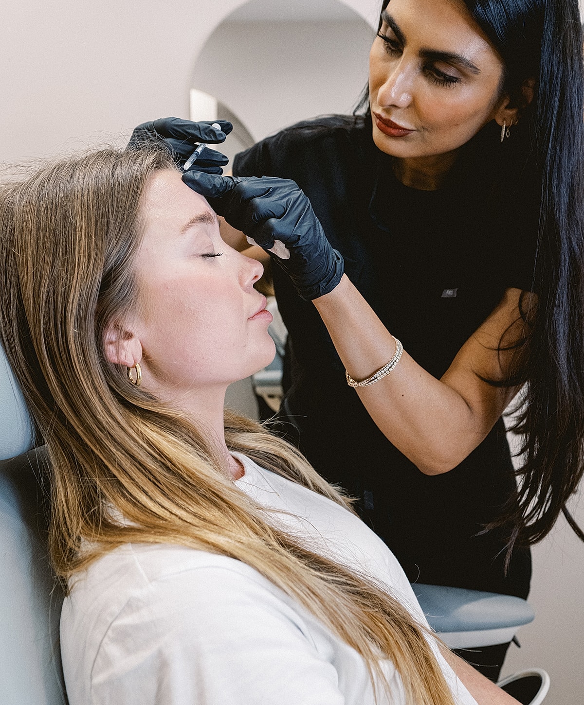 Client receiving cosmetic procedure at beauty clinic.
