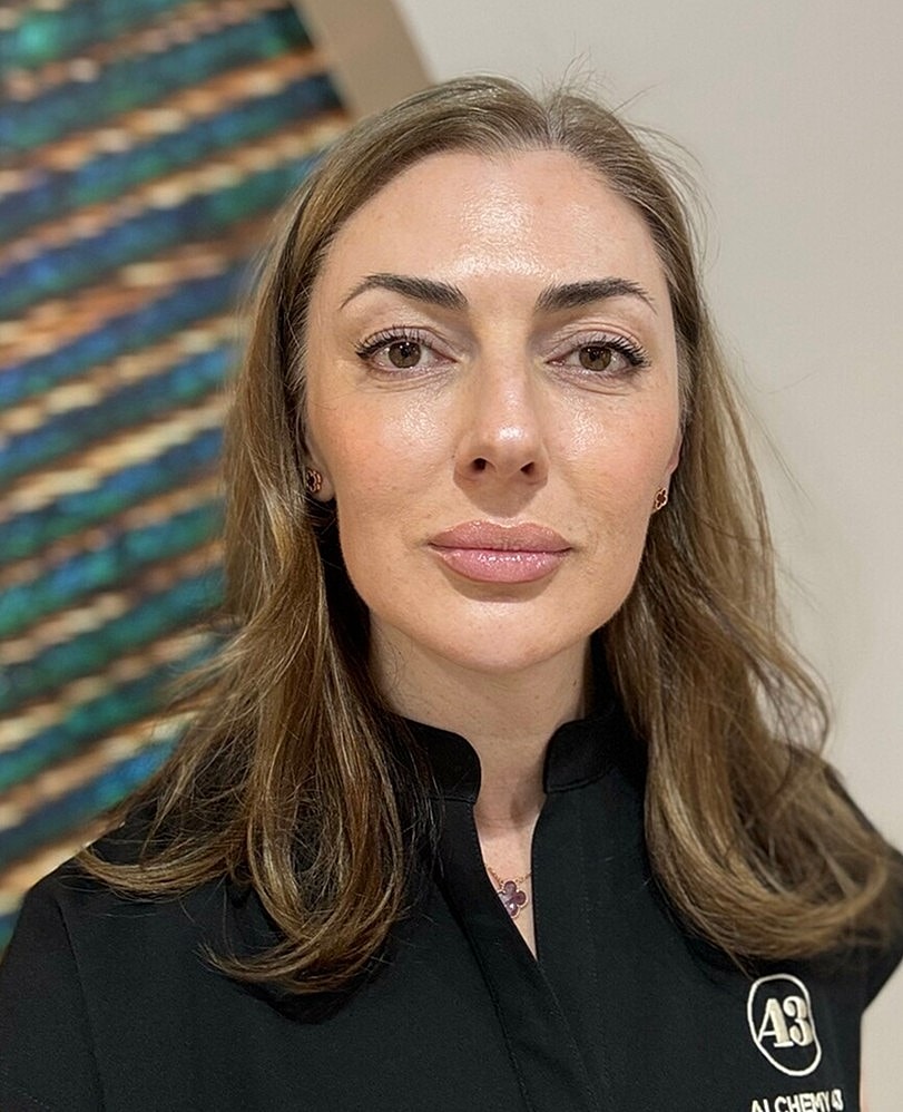 Person with long hair in black attire.