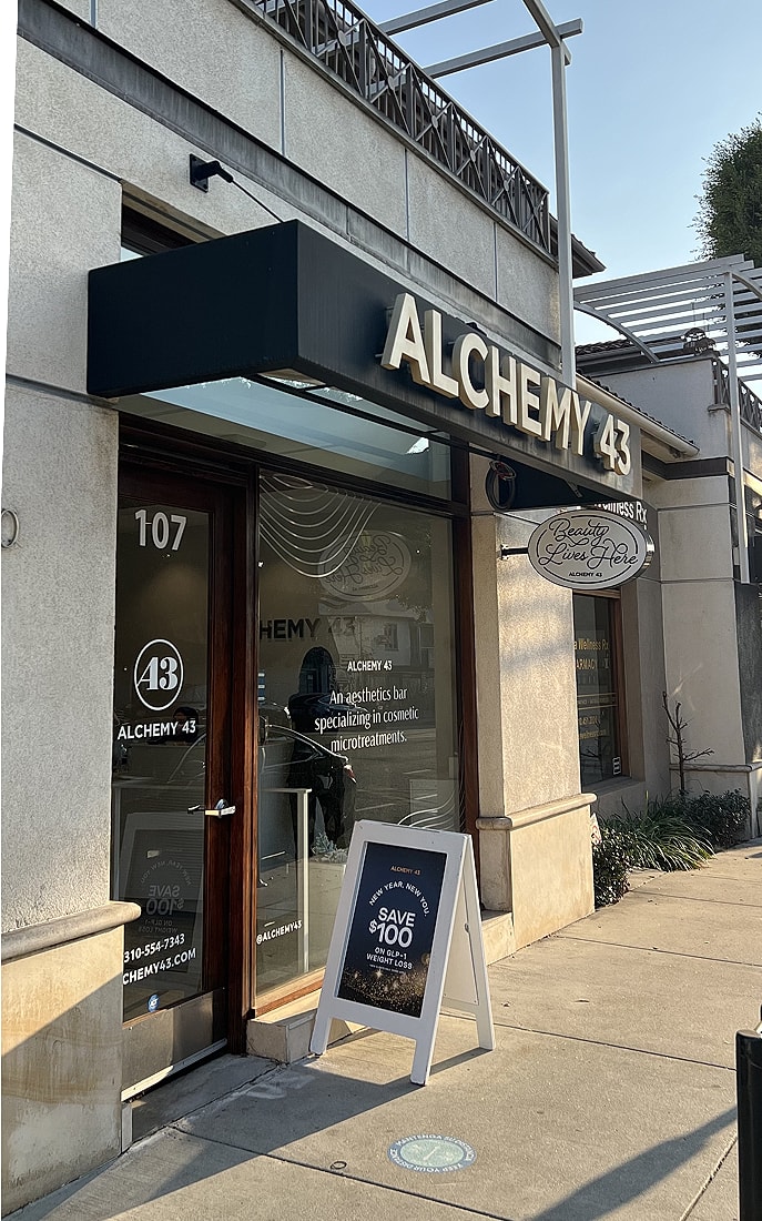 Aesthetic bar sign promoting microtreatments and discounts.