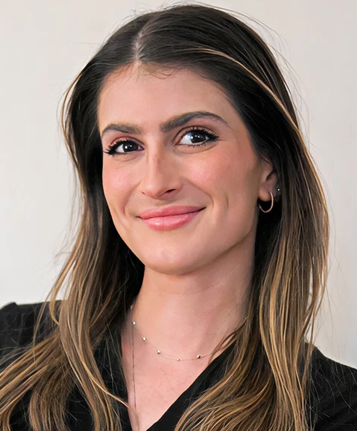 Young woman smiling with long hair.