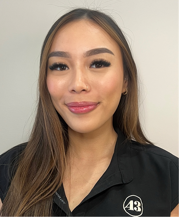 Young woman smiling with long hair.