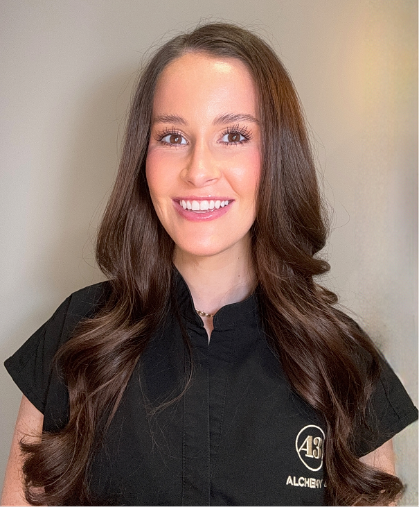 Smiling woman in professional attire against background.