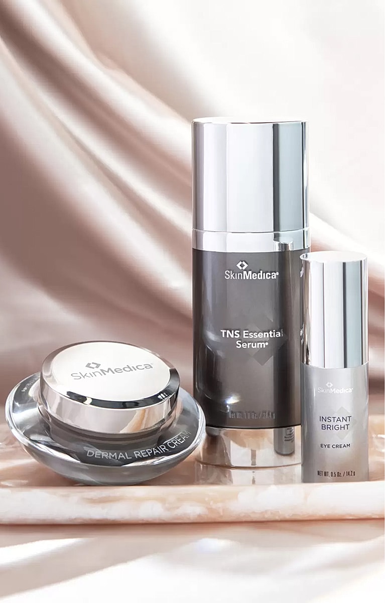 SkinMedica skincare products on a marble surface.