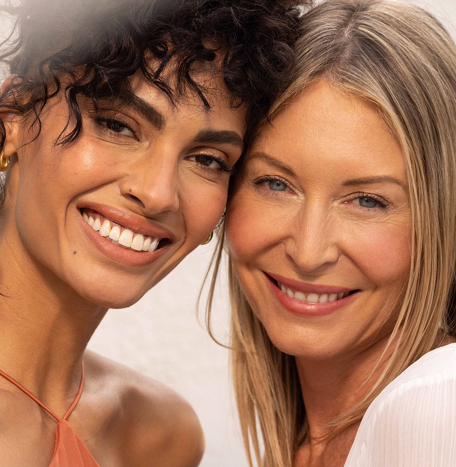 Two smiling women posing together.