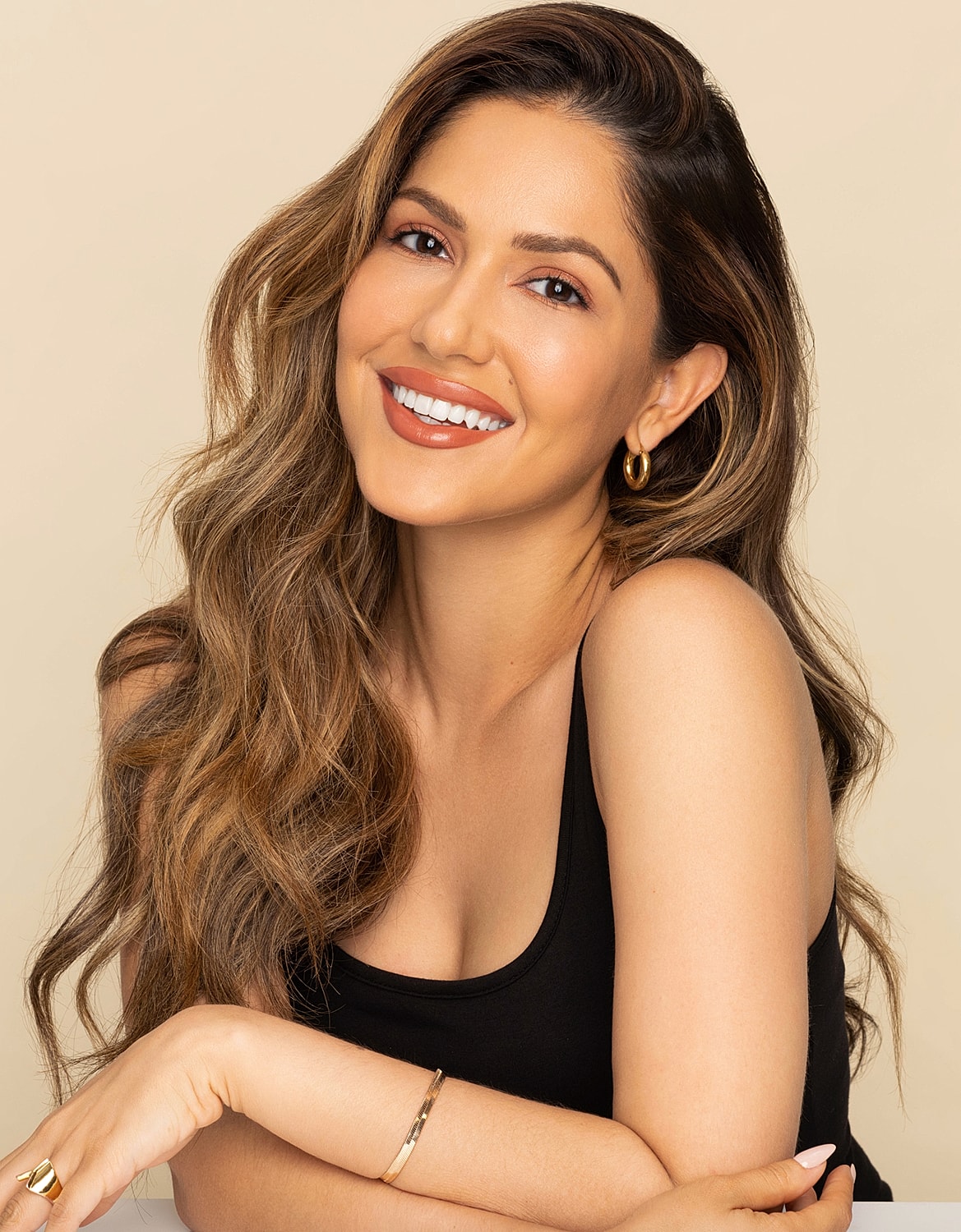 Smiling woman with long, wavy hair.