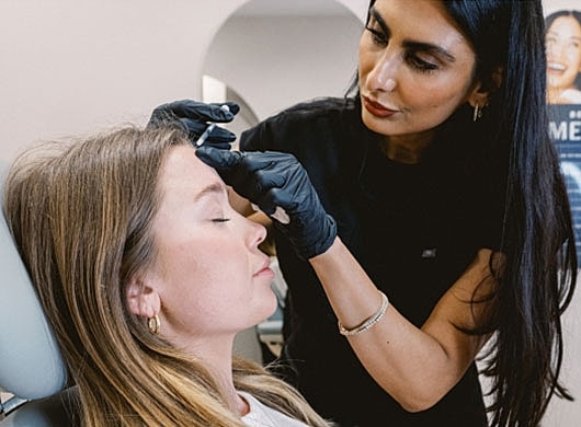Beauty professional performing a cosmetic treatment.