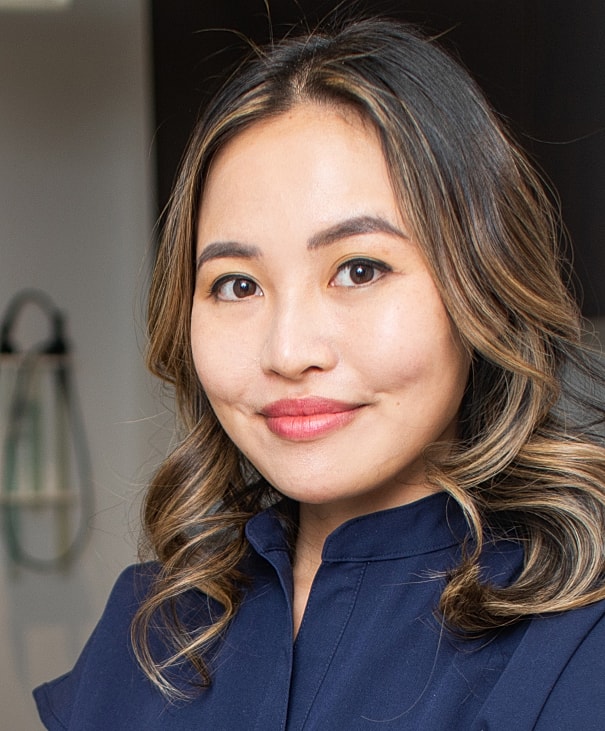 Young woman smiling with long hair.
