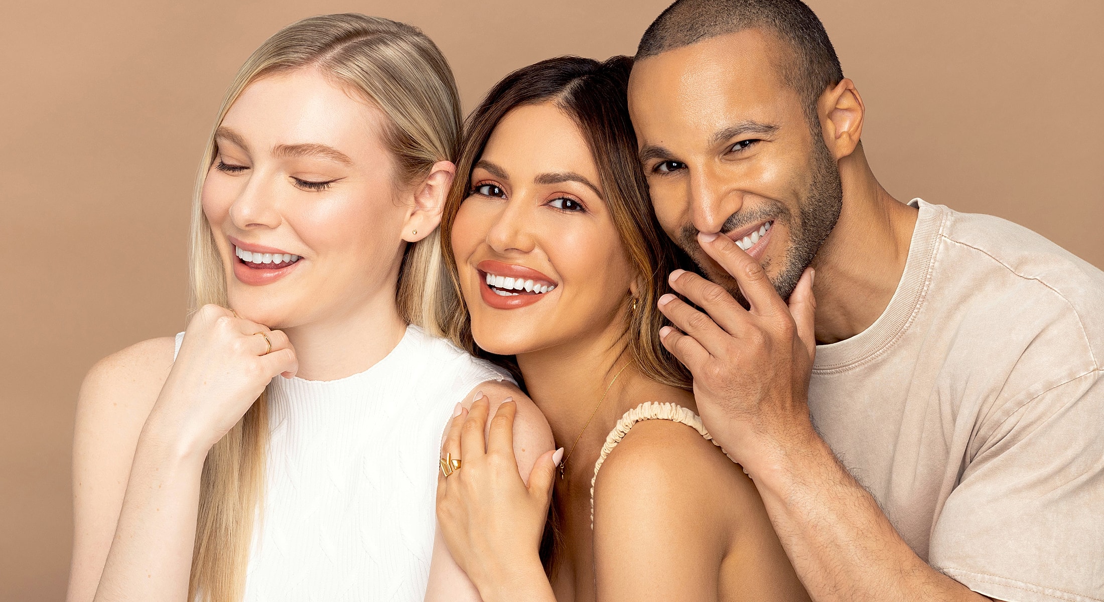 Three smiling friends enjoying a joyful moment.