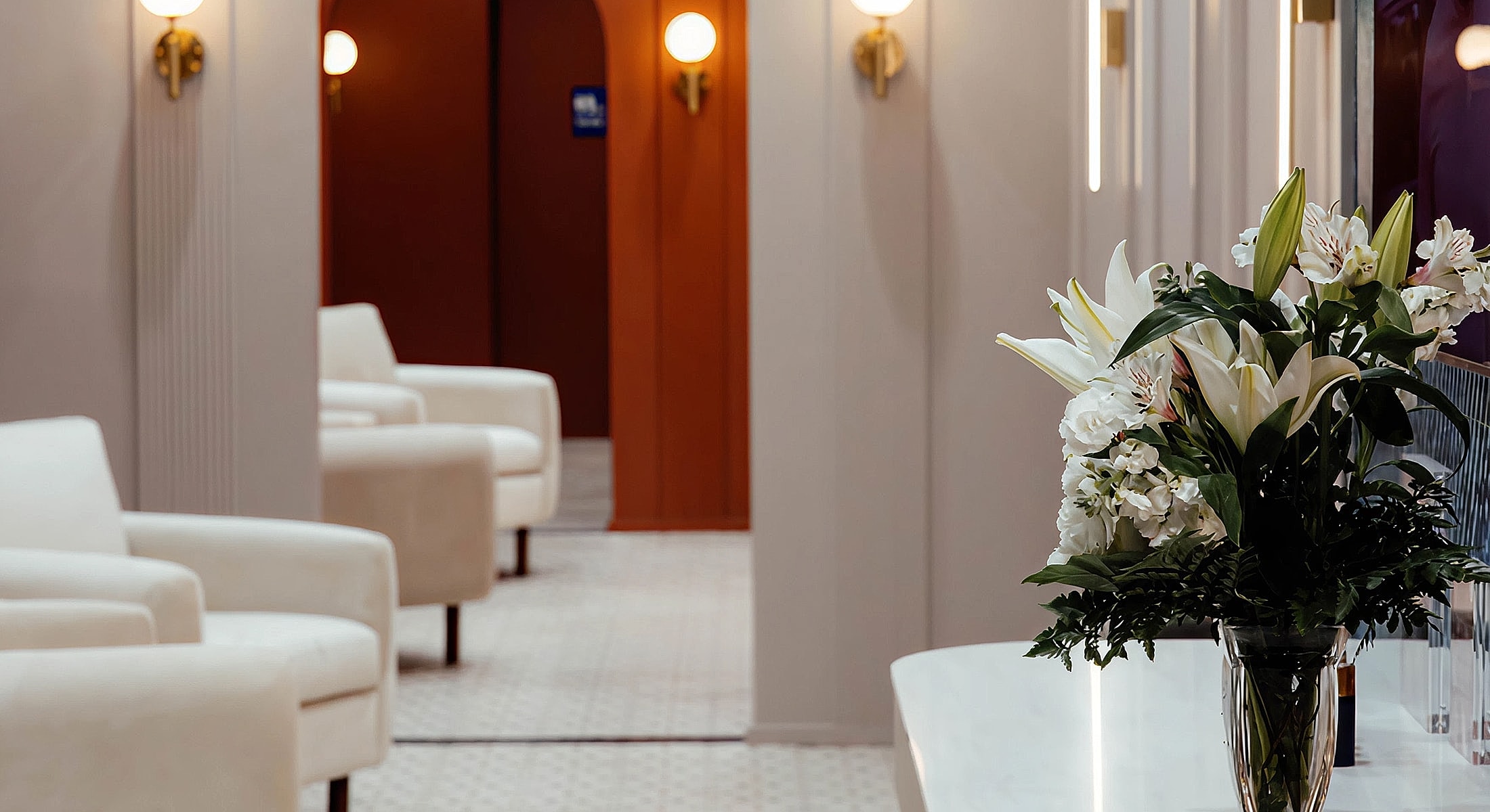 Modern interior with flowers and seating area.