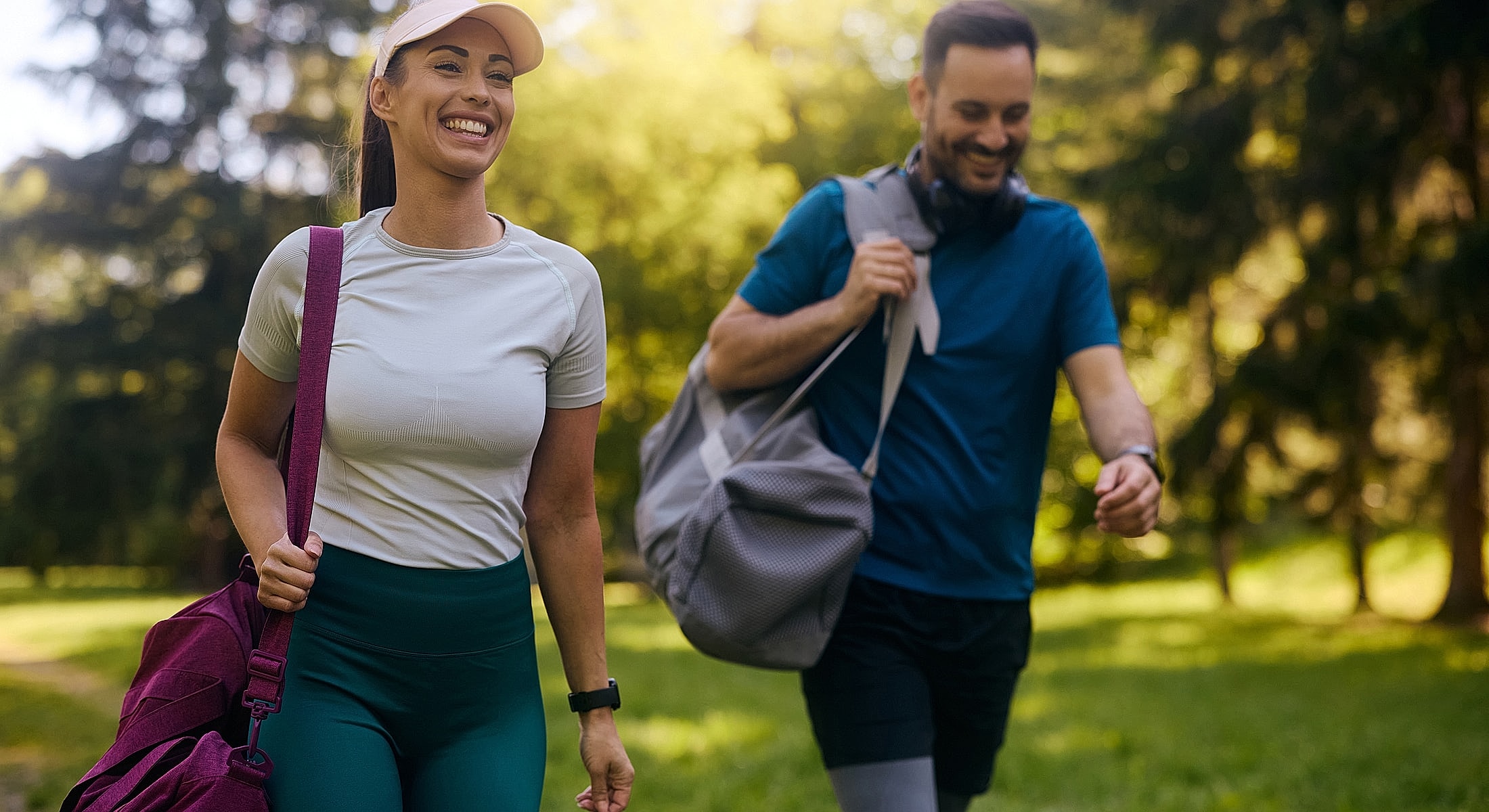 Couple enjoying a walk in nature with bags.